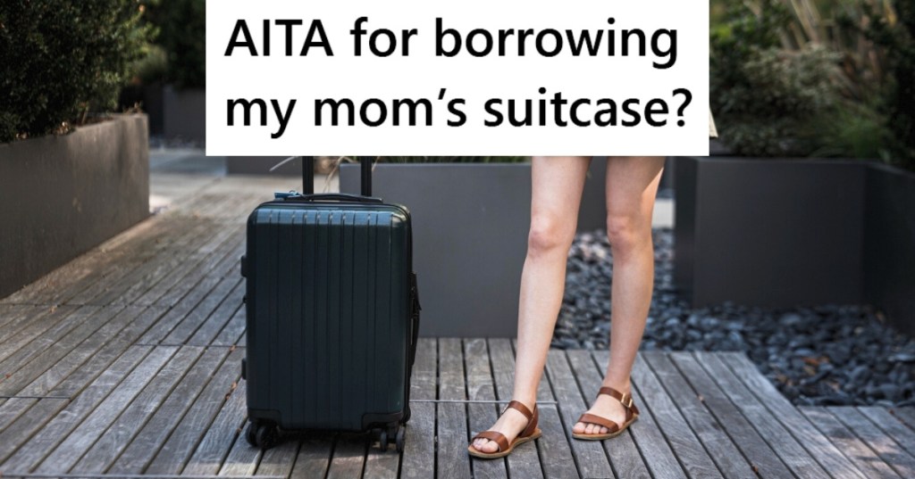 Woman alongside black suitcase