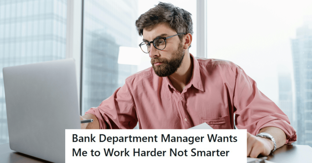 Man in pink shirt working on a laptop
