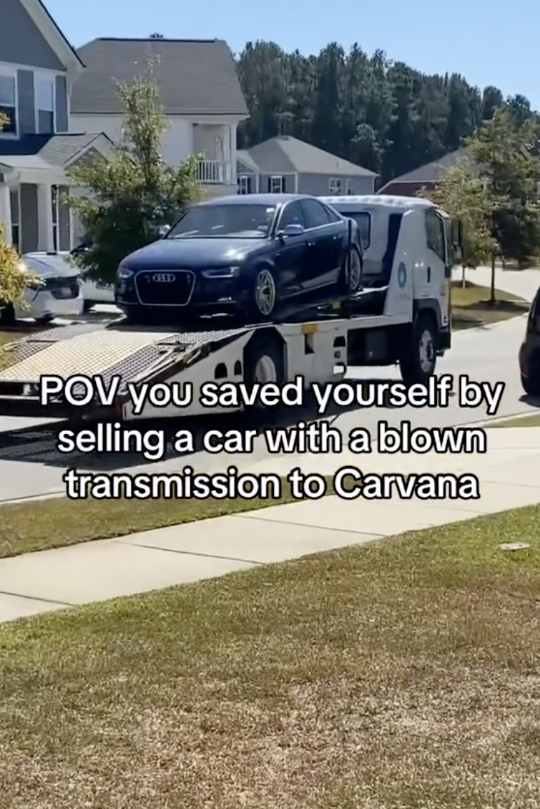 car being towed down a street